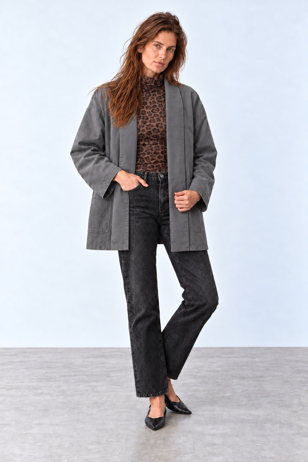 Gabi brown leopard-print turtleneck layered under a grey jacket