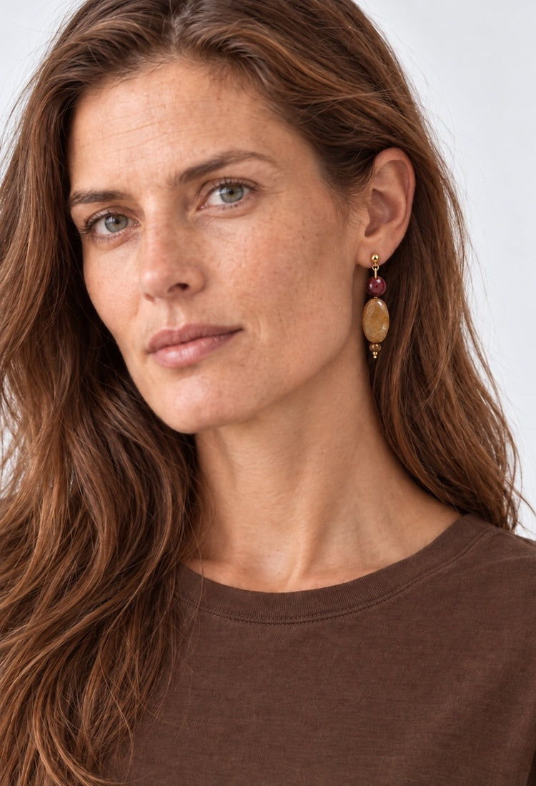 Bordeaux and amber stone drop earrings worn on model